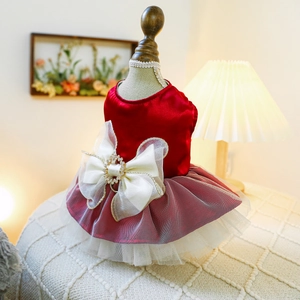 Close-up of red satin dog dress with pearl bow and layered white mesh skirt details