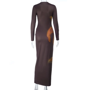 Detail of the back view of a slim fit brown maxi dress with orange abstract prints