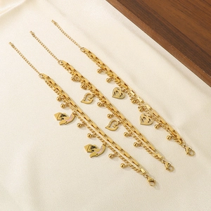 Detailed view of three layered gold heart bracelets with elegant hollow pendants and chains