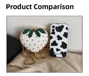 Close-up of strawberry-shaped chain bag with gold rivets and leaf detail next to a phone