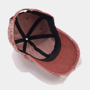 Close-up of vintage washed burgundy baseball cap showing inner seams and frayed edges