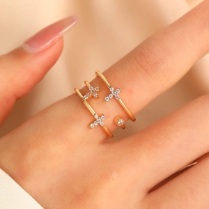 Gold multi-layer open ring with cross design and pave-set zircons on hand
