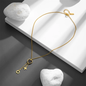 Golden titanium steel necklace with black heart and clover pendant on stone stand