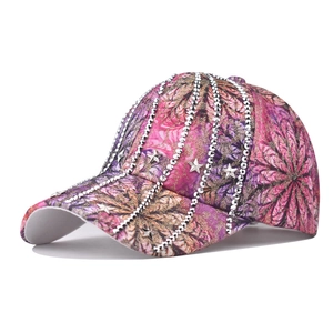 Close-up of sparkling silver rhinestones and star studs on colorful baseball cap fabric