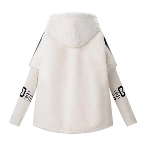 Detailed close-up of white plush hooded faux fur jacket with contrast patterned sleeve cuffs