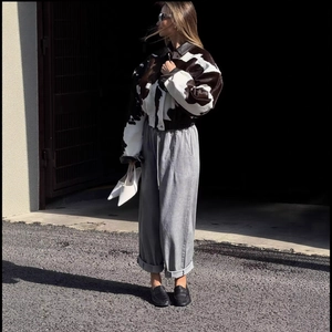 Women's stylish cow print suede cropped jacket paired with casual grey drawstring pants