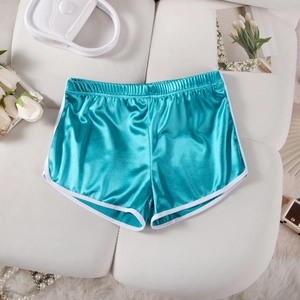 Flat lay of satin sports shorts in lake blue with white piping on a white quilted background