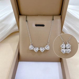 Detail of silver clover heart necklace with crystals in folding and open view