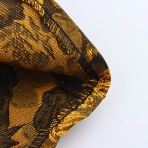 Close-up of vintage court style A-line dress featuring yellow and black jacquard fabric texture