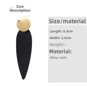 Detail view of long geometric drop earrings with 8.3cm length and 2.0cm width specs