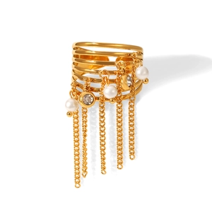 Detail view of gold fringe ring with white pearls and sparkling crystal tassels