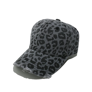 Close-up of distressed brim details on gray leopard print washed denim baseball cap