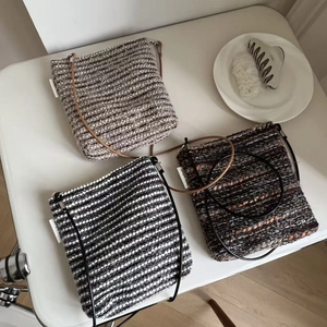 Three retro striped knitted crossbody bags with simple wish labels on white background