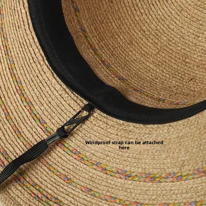 Detail of raffia straw hat inner band showing the detachable windproof rope hook attachment
