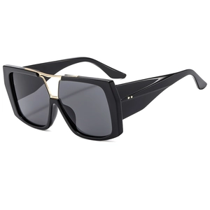 Classic black pilot sunglasses with gold double bridge and dark lenses on white background