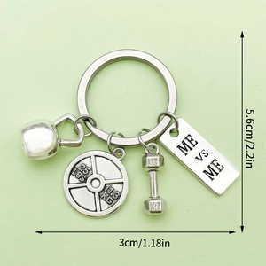 Detail of metal gym keychain featuring kettlebell, barbell weight, and dumbbell charms
