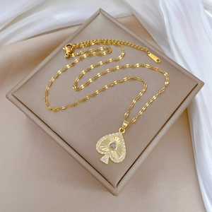 Elegant gold titanium steel necklace with sparkling heart playing card pendant and purple gem
