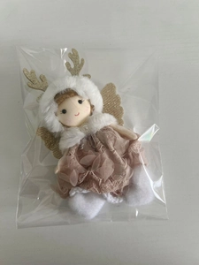 Detail view of pink plush Christmas doll ornament with gold antlers in clear packaging