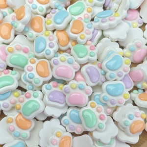 Macro shot of colorful resin cat paw charms for DIY nail art and craft decoration