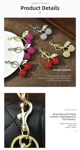 Detailed view of rhinestone cherry bag charms with lobster clasp and gold-plated hardware