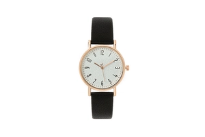 Detail of rose gold case with textured white dial and black leather strap on quartz watch