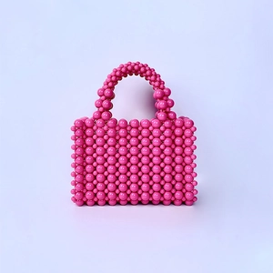 Close-up of pink beaded handbag with high quality acrylic pearls and woven design