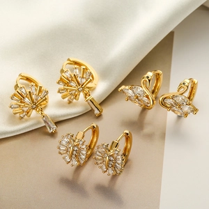 Luxury gold plated earrings set with swan, fan and floral crystal designs on silk
