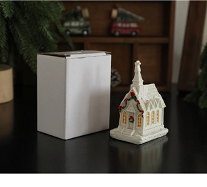 Detail of a white resin Christmas glowing church miniature with mini festive garlands
