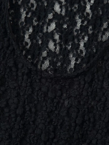 Close-up detail of black lace mesh and textured 3D bubble fabric on women bodysuit