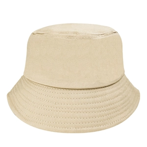 Detail view of cotton bucket hat stitching and beige fabric texture on white background