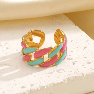 Gold chain open ring with colorful pink and turquoise enamel on textured marble