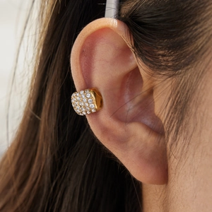 Macro shot of 18K gold plated stainless steel ear cuff with sparkling zircon inlay