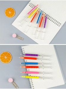 Set of six syringe-shaped highlighters in multiple colors on a spiral notebook