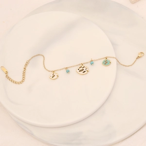 Gold stainless steel bracelet with turquoise beads and turquoise enamel fish charms