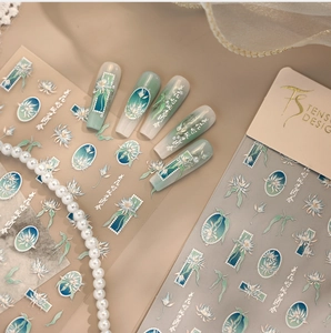 Detail of embossed floral nail stickers with mint green gradient and 3D pearl accents