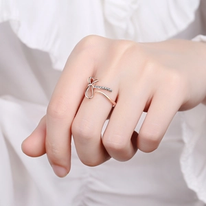 Elegant rose gold bow ring for women featuring pavé diamonds and a minimalist open design