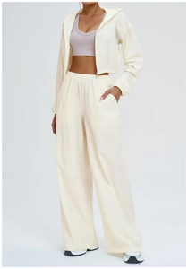 Detail of high-waist loose wide-leg pants with elastic waistband and functional pockets