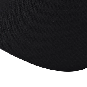 Macro shot of black cotton-blend knit fabric showing fine honeycomb texture and fiber weave