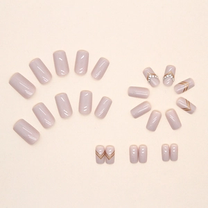 Elegant lavender press-on nails with gold V-stripes and rhinestones in square-oval shape