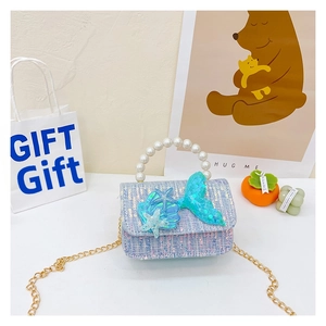 Detail of tweed girls' mini bag with pearl handle and sequin mermaid tail charm