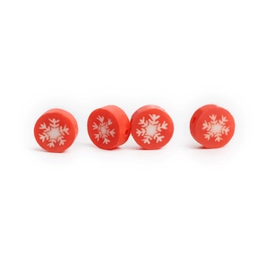 Detailed view of four red polymer clay beads with white snowflake patterns for DIY jewelry