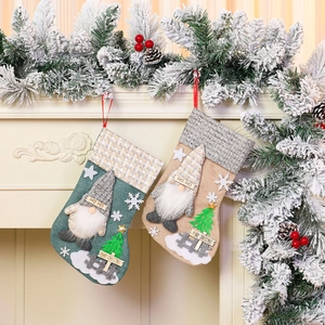 Hanging large linen Christmas stockings with 3D gnome dolls and festive decor