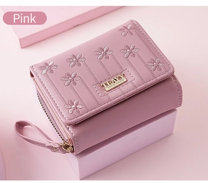 Detailed view of pink PU leather wallet with floral embroidery and gold snap button