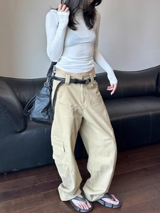 Detail of khaki wide-leg cargo pants with multi-pockets and cotton twill texture
