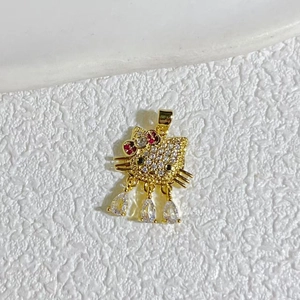 Macro view of gold-plated Hello Kitty pendant with zircon inlay and teardrop charms