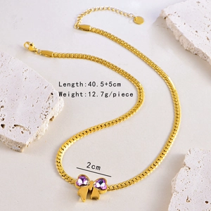 Detailed close-up of golden snake chain necklace with purple bow pendant and size specifications