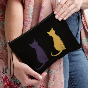Black canvas makeup bag with cute cat prints and a practical wristlet strap