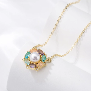 Gold plated necklace featuring a floral pendant with a pearl and colorful zircons