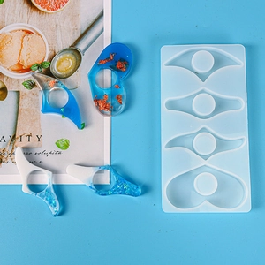 Macro detail of silicone resin mold with blue heart and eye shaped page holder bookmarks