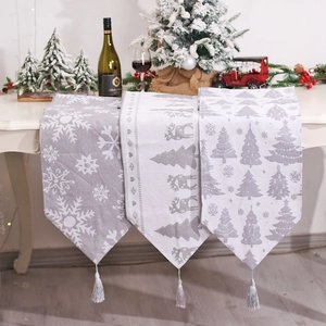 Grey Christmas table runner with snowflake and reindeer patterns and tassel charms